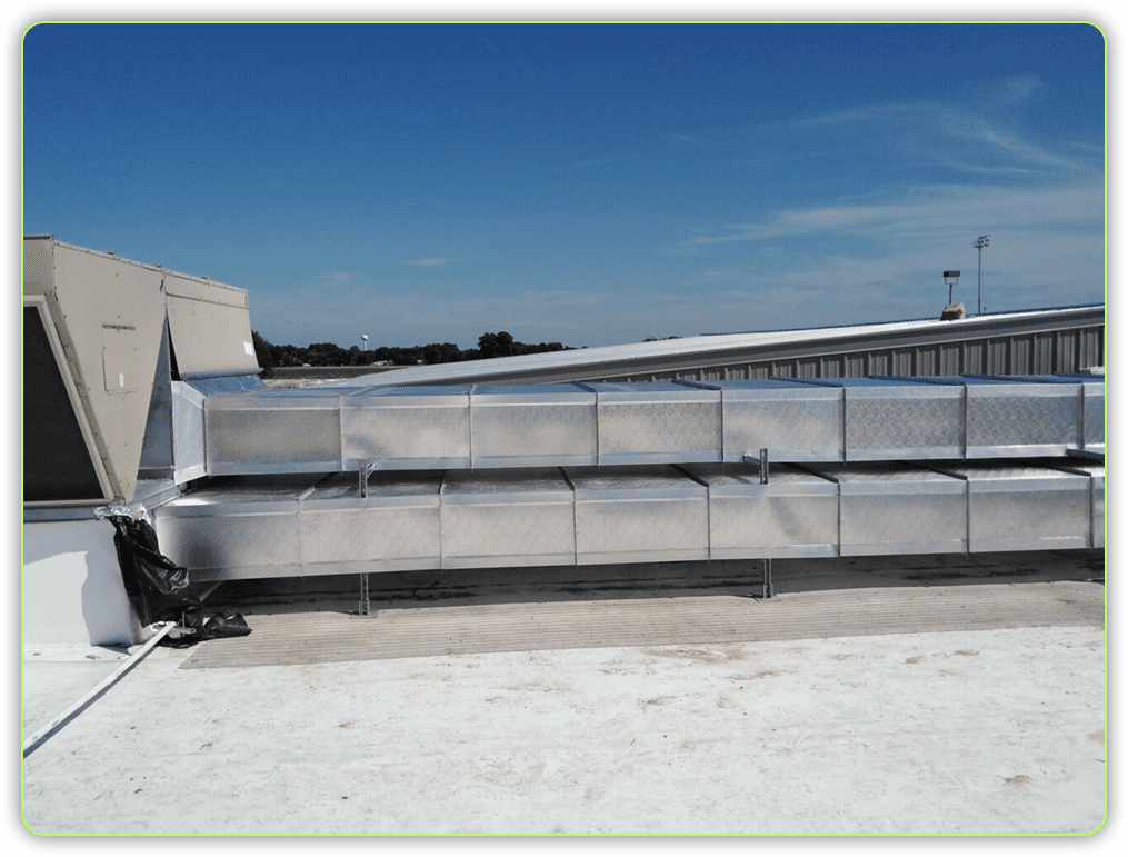 A large metal fence sitting on top of a concrete field.