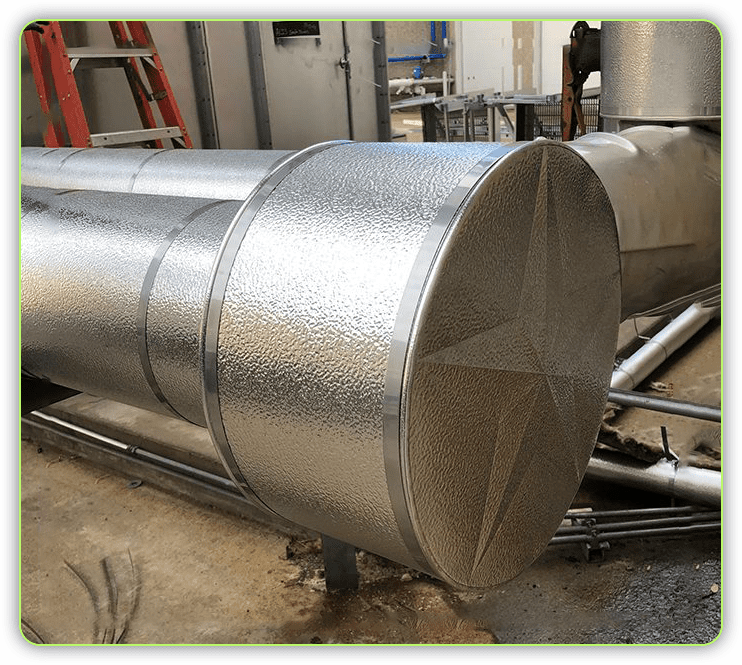 A large metal pipe sitting in the middle of a room.