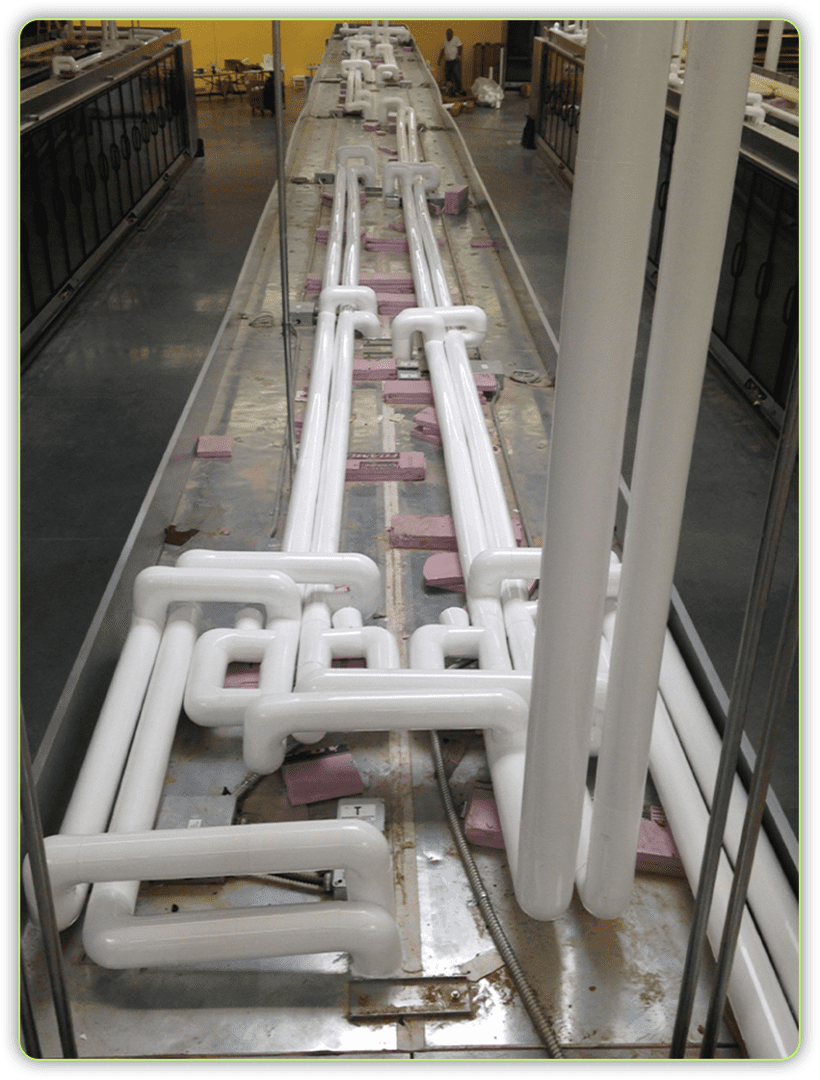 A long white pipe system in the middle of a building.