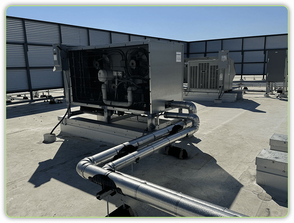 A large industrial air conditioner on the roof of an office building.