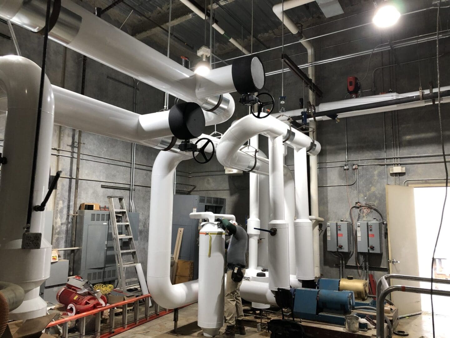 A large room with many pipes hanging from the ceiling.