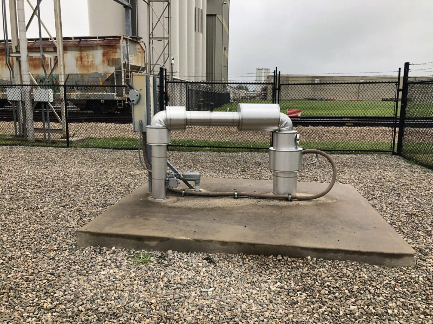 A white and silver pump sitting on top of gravel.