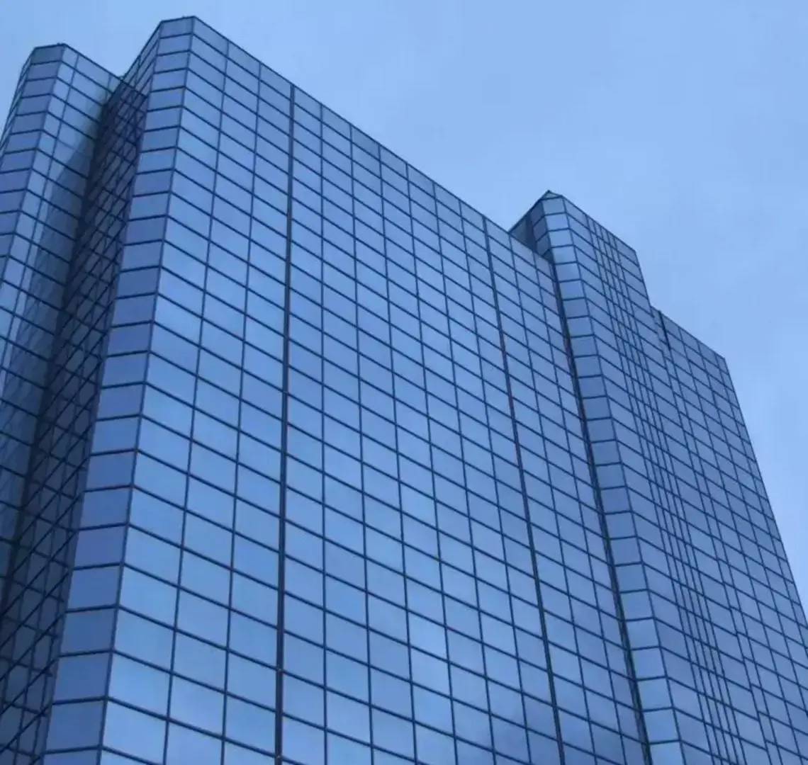 A tall building with many windows on the outside.